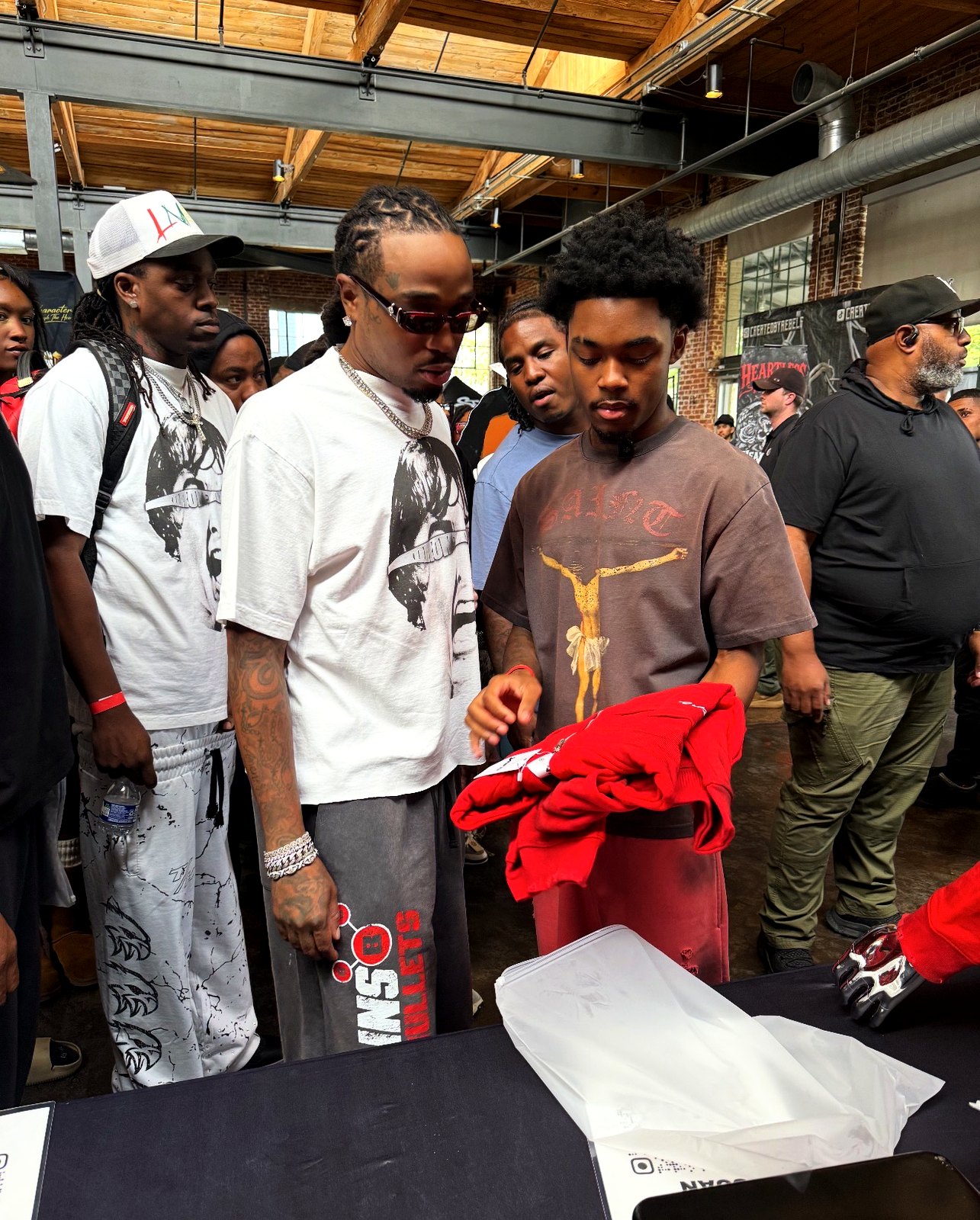 A folded red YARE jacket being shown to shoppers at the YARE booth