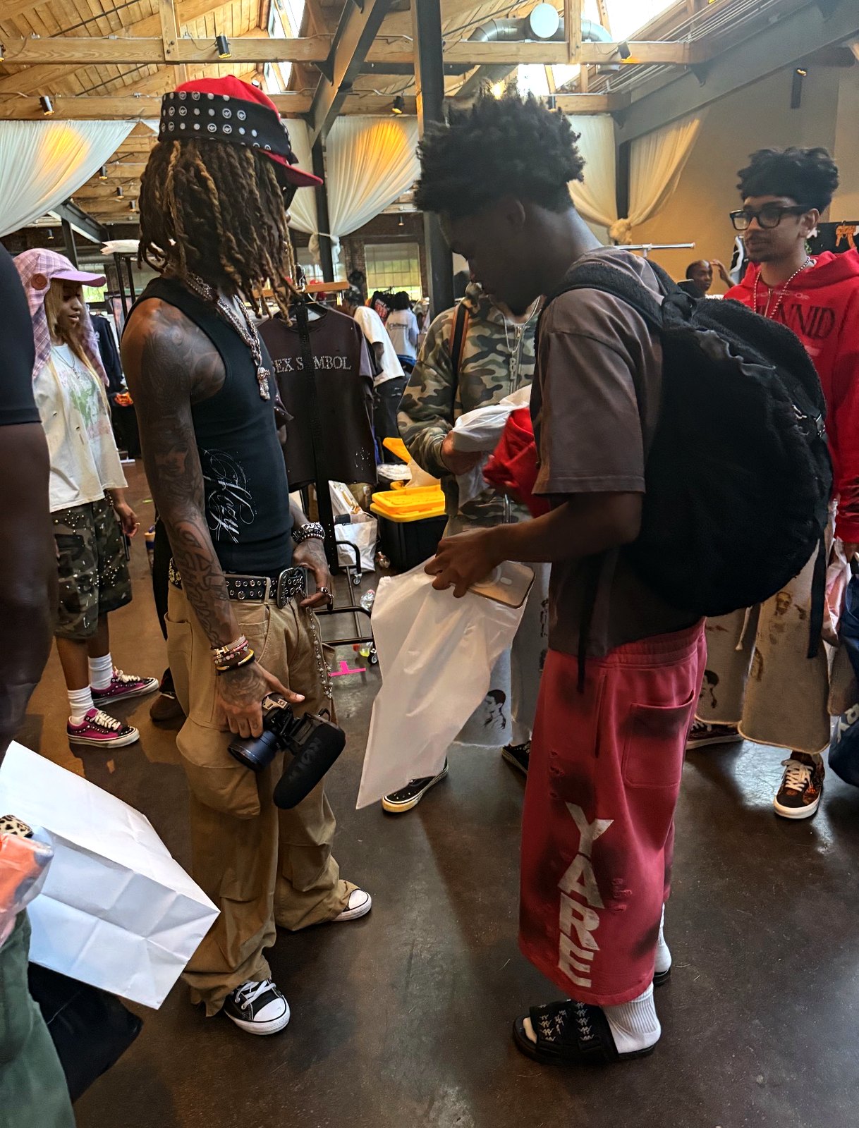 YARE sweats with the YARE leg print worn on the floor of the streetwear market